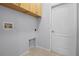 Simple laundry room featuring built-in cabinets and tile flooring at 2389 Grand Poplar St, Ocoee, FL 34761