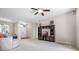 Spacious living room features neutral carpet, ceiling fan, and dark wood entertainment center at 2389 Grand Poplar St, Ocoee, FL 34761