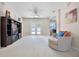 Bright living room with neutral carpet, ceiling fan, white trim, and doors to lanai. Entertainment center in view at 2389 Grand Poplar St, Ocoee, FL 34761