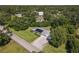 This aerial view showcases a home with solar panels, mature trees, and a well-manicured lawn at 2450 W Lake Dr, Deland, FL 32724