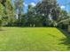 A vast backyard with lush greenery, mature trees, and ample space for recreation and relaxation at 2450 W Lake Dr, Deland, FL 32724