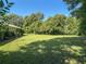 Expansive backyard featuring well-maintained lawn, mature trees, and plenty of space for outdoor activities at 2450 W Lake Dr, Deland, FL 32724