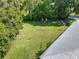 Spacious backyard featuring a lush lawn, mature trees, and ample space for outdoor activities at 2450 W Lake Dr, Deland, FL 32724