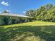 Lush backyard showcasing a well-maintained lawn, mature trees, and a serene outdoor space at 2450 W Lake Dr, Deland, FL 32724