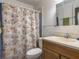 Bathroom featuring a toilet, vanity, mirror, and shower with sea-themed shower curtain at 2450 W Lake Dr, Deland, FL 32724
