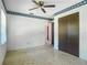 Bedroom with floral trim, ceiling fan, closet, and access to a hallway at 2450 W Lake Dr, Deland, FL 32724