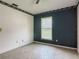This bedroom features a neutral carpet, a window with blinds, and decorative wallpaper at 2450 W Lake Dr, Deland, FL 32724