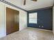 Bedroom with built in closet and blue accent wall and views of backyard at 2450 W Lake Dr, Deland, FL 32724