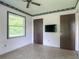 Bedroom with a window, closet, television mounted on the wall, and access to a hallway at 2450 W Lake Dr, Deland, FL 32724