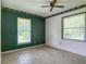 Bedroom with two windows and views of backyard at 2450 W Lake Dr, Deland, FL 32724