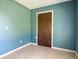 Bedroom with a closet and blue patterned wallpaper at 2450 W Lake Dr, Deland, FL 32724