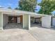 Exterior view of three-car garage with garage doors open at 2450 W Lake Dr, Deland, FL 32724