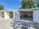 Exterior view of three-car garage with garage doors open at 2450 W Lake Dr, Deland, FL 32724