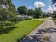 Charming home featuring a well-manicured front yard, lush landscaping, and a welcoming curb appeal at 2450 W Lake Dr, Deland, FL 32724
