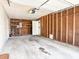 View of an open garage with concrete flooring, shelving and interior access at 2450 W Lake Dr, Deland, FL 32724