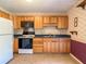 Bright kitchen with wood cabinets, black appliances, and blue countertops, ready for meal prep at 2450 W Lake Dr, Deland, FL 32724