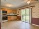 Eat-in kitchen featuring wood cabinets and a sliding glass door that leads to the backyard at 2450 W Lake Dr, Deland, FL 32724
