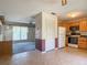 View from kitchen showing kitchen cabinets, appliances and view into living room at 2450 W Lake Dr, Deland, FL 32724