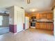View from kitchen showing kitchen cabinets, appliances and view into living room at 2450 W Lake Dr, Deland, FL 32724