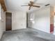 Cozy living room with a ceiling fan, large window, and neutral-colored walls and carpet at 2450 W Lake Dr, Deland, FL 32724