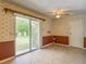 Living room with sliding glass door leading to the backyard and additional door to outside at 2450 W Lake Dr, Deland, FL 32724