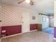 Inviting living room area with neutral carpet, ceiling fan and access to the outside at 2450 W Lake Dr, Deland, FL 32724
