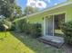 Patio featuring a covered outdoor space, lush greenery, and a tranquil setting for relaxation at 2450 W Lake Dr, Deland, FL 32724