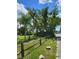 Landscaped property with lush green trees and a split rail fence at 2611 Hiawatha Ave, Sanford, FL 32773