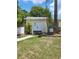Inviting home exterior featuring a white picket fence, fresh lawn, and double doors at 2611 Hiawatha Ave, Sanford, FL 32773