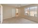 A large bedroom features a ceiling fan, a window, a closet, and an attached bathroom and a desk at 2717 Bushman Dr, Kissimmee, FL 34746