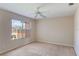 Spacious empty bedroom with neutral walls, carpet, a ceiling fan and a window offering a view of the community at 2717 Bushman Dr, Kissimmee, FL 34746