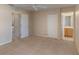 A large bedroom featuring a ceiling fan, two closets and an attached bathroom at 2717 Bushman Dr, Kissimmee, FL 34746