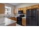 Modern kitchen featuring oak cabinetry, laminate countertops, and stainless steel appliances at 2717 Bushman Dr, Kissimmee, FL 34746
