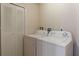 The laundry room features a white washer, dryer, and bifold closet for ample storage space at 2717 Bushman Dr, Kissimmee, FL 34746
