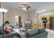 Comfortable living area with tile floors, ceiling fan, adjacent to an open kitchen and outdoor patio at 2717 Bushman Dr, Kissimmee, FL 34746
