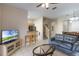 Bright living space with tile floors, open floor plan, ceiling fan, and open access to the kitchen at 2717 Bushman Dr, Kissimmee, FL 34746