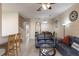 Comfortable living area with an open floor plan, tile flooring, access to the kitchen, and staircase at 2717 Bushman Dr, Kissimmee, FL 34746