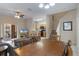 Open-concept living and dining area with staircase and kitchen access and sliding door access to backyard at 2717 Bushman Dr, Kissimmee, FL 34746