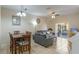 An open-concept living and dining area with neutral decor, tile flooring, and access to outdoor patio at 2717 Bushman Dr, Kissimmee, FL 34746