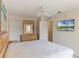 A spacious main bedroom includes a ceiling fan, a dresser with mirror, a TV and a walk-in closet at 2717 Bushman Dr, Kissimmee, FL 34746