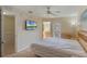 The main bedroom features a ceiling fan, a TV, a dresser, a sliding glass door to a balcony, and an en suite bathroom at 2717 Bushman Dr, Kissimmee, FL 34746