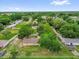 Top-down view showcasing the property among mature trees within a Gathering-friendly neighborhood at 302 W Rose Ln, Lady Lake, FL 32159