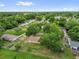 Aerial view of the property within a leafy neighborhood, highlighting its attractive location at 302 W Rose Ln, Lady Lake, FL 32159