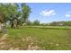 Expansive backyard features lush greenery and mature trees, perfect for outdoor activities and relaxation at 302 W Rose Ln, Lady Lake, FL 32159