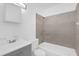 This bathroom features a shower over tub, modern vanity, and a neutral color palette at 302 W Rose Ln, Lady Lake, FL 32159