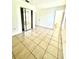 Bright bedroom featuring a closet and large tile flooring at 302 W Rose Ln, Lady Lake, FL 32159