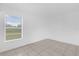 Neutral-colored, empty bedroom is flooded with natural light from the window at 302 W Rose Ln, Lady Lake, FL 32159