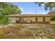 Charming single-story home with a well-maintained yard, front access ramp, and attached garage at 302 W Rose Ln, Lady Lake, FL 32159