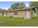 Back exterior view of home featuring a fenced yard, AC Unit, and an access door at 302 W Rose Ln, Lady Lake, FL 32159