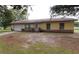 Charming one-story home with a well-manicured lawn and attached garage at 302 W Rose Ln, Lady Lake, FL 32159